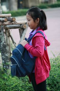 Side view of girl standing on field