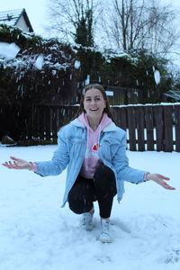 Portrait of smiling young woman in snow