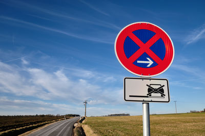 Road sign against sky