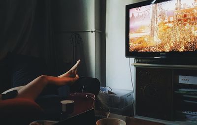 Low section of person sitting on sofa at home