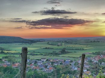 Scenic view of field against sky during sunset