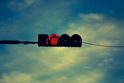 Low angle view of road signal against sky