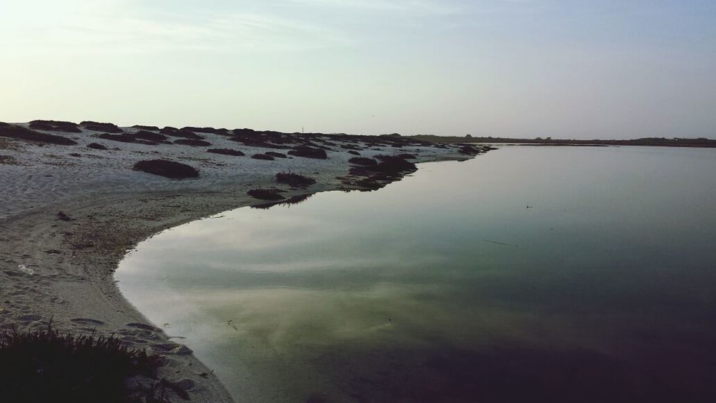 water, sky, tranquility, tranquil scene, sea, scenics, beach, beauty in nature, nature, cloud - sky, shore, horizon over water, reflection, rock - object, sand, idyllic, cloud, outdoors, non-urban scene, day