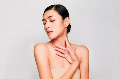 Portrait of a beautiful young woman over white background