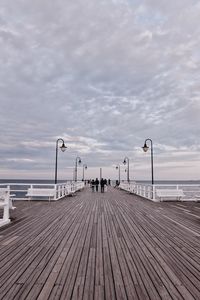 Surface level of pier on sea against sky