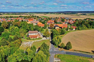 High angle view of houses and trees against sky