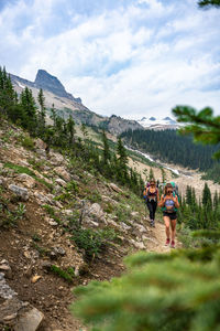 Two backpackers hiking along the whaleback trail in yoho national park