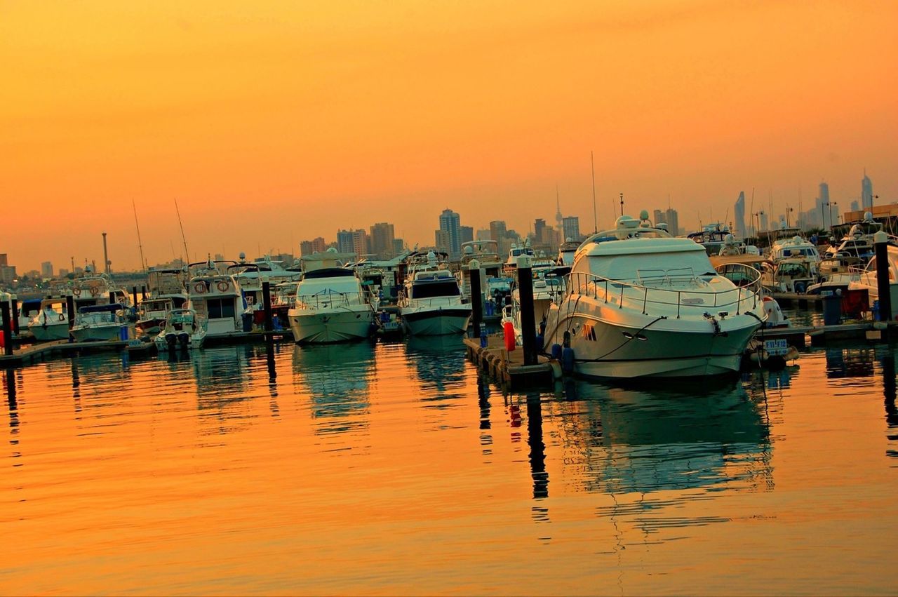 nautical vessel, sunset, transportation, boat, mode of transport, moored, water, waterfront, orange color, harbor, reflection, built structure, architecture, building exterior, mast, river, clear sky, sea, sky, travel