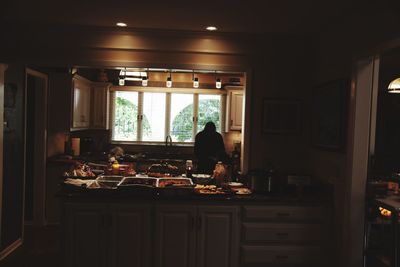 Rear view of man standing on table at home