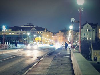 People walking on road at night