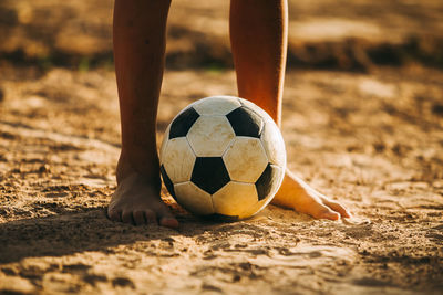 Low section of person playing soccer ball