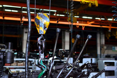 Low angle view of lighting equipment hanging in factory