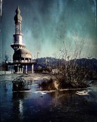 Reflection of illuminated built structure in water