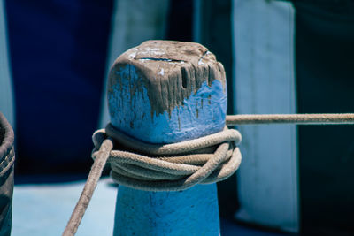 Close-up of rope tied on wooden post