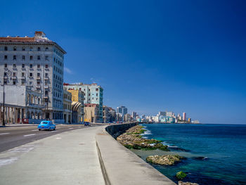 Buildings against clear blue sky