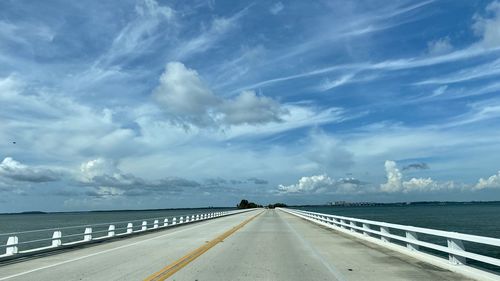 Road by sea against sky