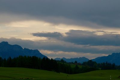Scenic view of mountains against cloudy sky