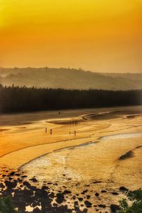 Scenic view of beach against sky during sunset