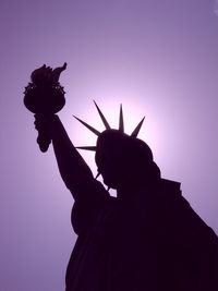 Silhouette statue of liberty against sky