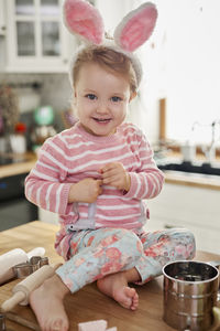 Portrait of smiling girl sitting on table