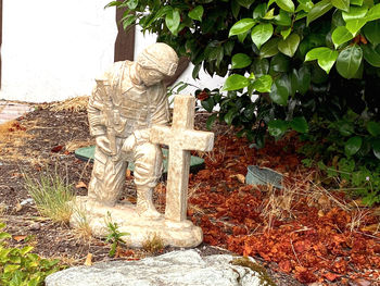 Statue amidst trees on field