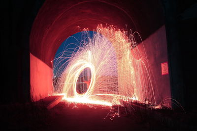 Illuminated light painting against sky at night