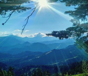 Scenic view of mountains against bright sun