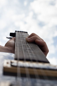 Midsection of person playing guitar