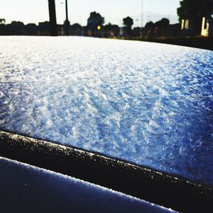 Close-up of frozen water against sky