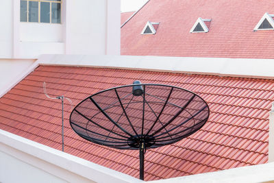 Low angle view of satellite dish against building