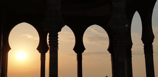 Low angle view of bridge against sky during sunset