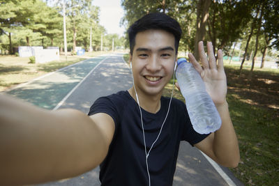 Portrait of smiling young man in city