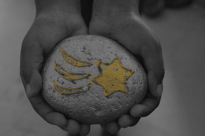 Close-up of person holding human hand