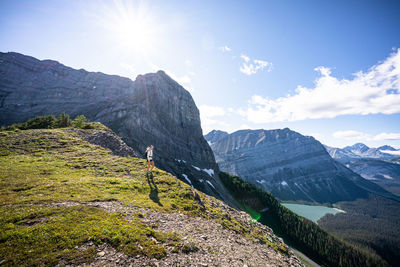 Hiker walking along sarrail ridge during sunset in summer