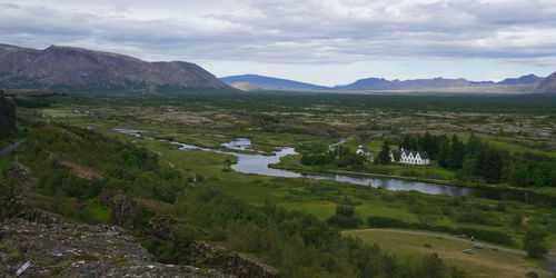 Scenic view of landscape and river against sky