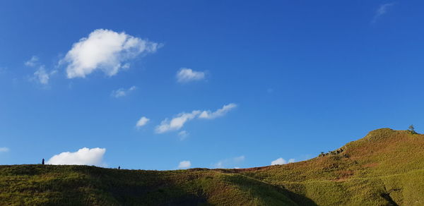 Low angle view of mountain against blue sky