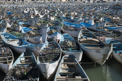 High angle view of fishing boats moored at harbor