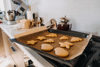 Christmas homemade gingerbread biscuit at baking pan on home kitchen. cooking at home, gingerbread