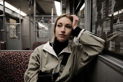 Thoughtful young woman sitting in train