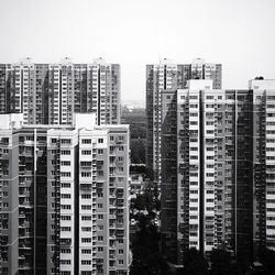 Residential buildings in city against clear sky