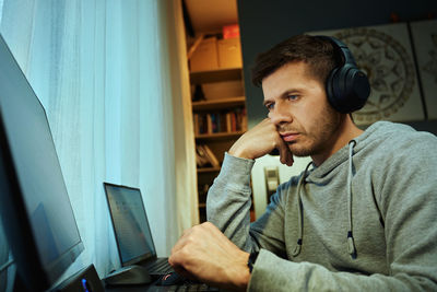 Young man using laptop at home