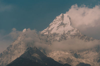 Scenic view of snowcapped mountains against sky during sunset