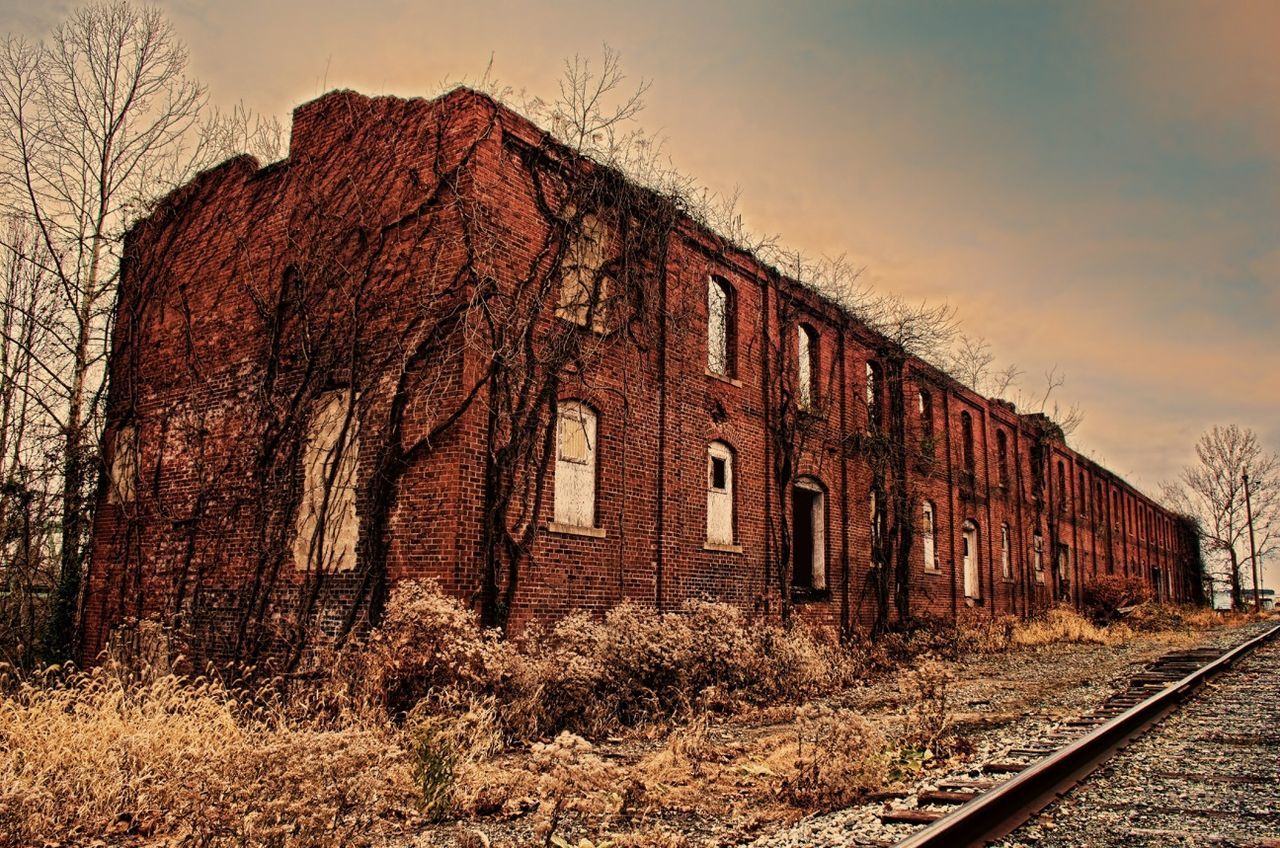 architecture, built structure, building exterior, sky, abandoned, house, old, cloud - sky, outdoors, no people, tree, day, plant, field, sunset, bare tree, building, railroad track, residential structure, nature