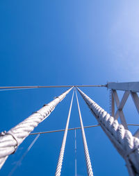 Low angle view of bridge against clear blue sky