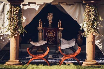 Illuminated traditional building by plants at night