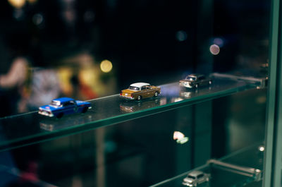 Toy cars on glass shelf