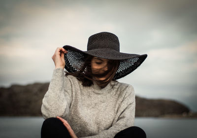 Rear view of woman wearing hat against sky