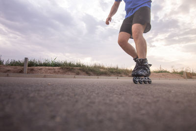 Low section of man rollerskating on land