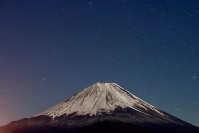 Volcanic crater against sky at night