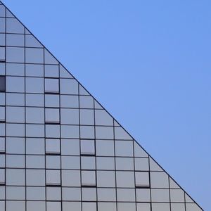 Low angle view of built structure against clear blue sky